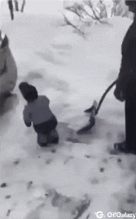 Baby child cleans snow