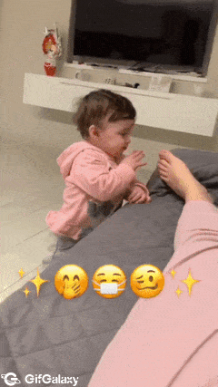 Baby smells smelly feet