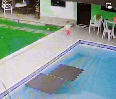 Caring father and baby in pool