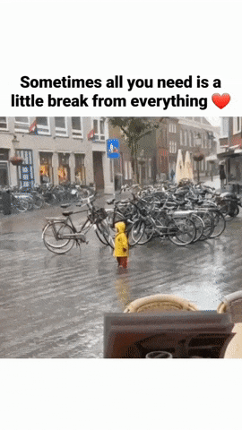 Child lies in puddle in rain