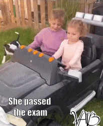 Girl drives boy in small car