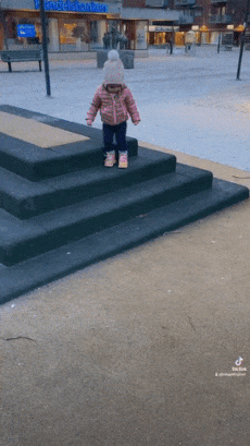 Little girl comes down the stairs