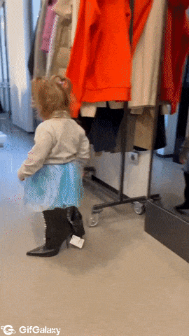Little girl in big heels and boots