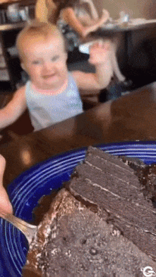 Feeding baby with help of cake