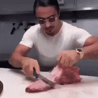 Chef cuts meat and boy