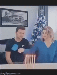 Husband and wife blow out candles