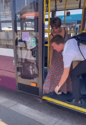 Bus driver help to woman with dress