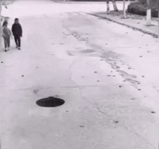 Children mark hole in road