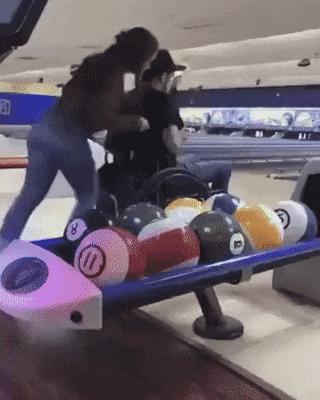 Girl and guy in wheelchair on bowling