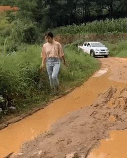 Car puddle and girl with stone