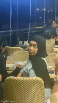 Guy feeds girl in restaurant