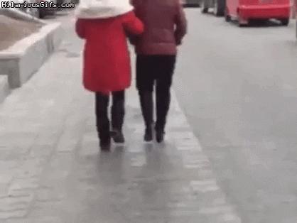 Guy and girl fall on street