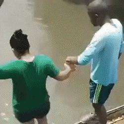 Guy and girl jump in river